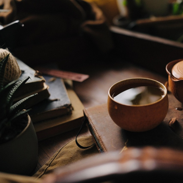 cozy teacup, candle, and soft knit blanket
